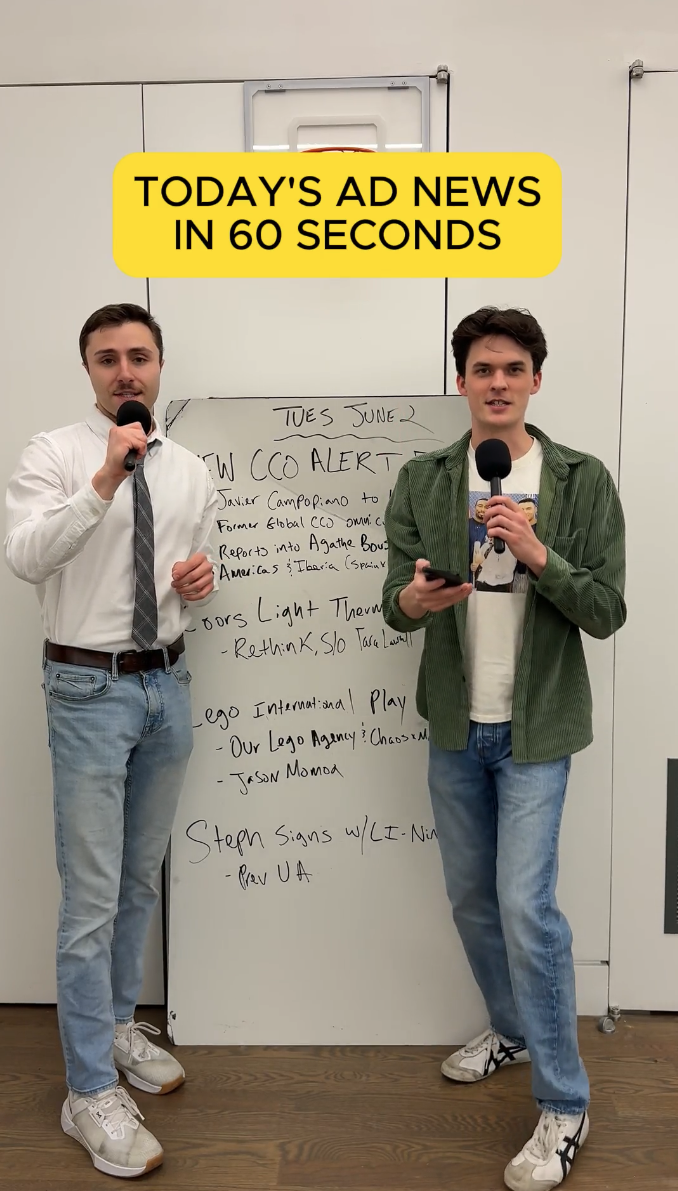 Two hosts standing in front of a whiteboard with today's ad news